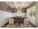 Elegant dining room with coffered ceiling, chandelier, and wainscoting at 2570 Reynolds Sw Rd, Atlanta, GA 30331