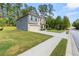 Side view of two-story home showcasing gray siding, stone accents, and a spacious lawn at 2570 Reynolds Sw Rd, Atlanta, GA 30331