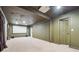 Spacious basement perfect for a media room with a projector screen and carpeting at 2656 Old Norcross Rd, Tucker, GA 30084