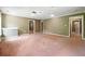 Large open basement area with carpet flooring at 2656 Old Norcross Rd, Tucker, GA 30084