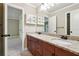 Bathroom featuring granite countertops with dual sinks, vanity with storage, and decorative lighting at 2656 Old Norcross Rd, Tucker, GA 30084