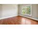 Cozy bedroom featuring hardwood floors, base trim, paint and a view of the backyard at 2656 Old Norcross Rd, Tucker, GA 30084