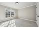 Bright bedroom featuring neutral paint, plush carpeting, and a window overlooking the outdoors at 2656 Old Norcross Rd, Tucker, GA 30084