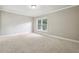 Well-lit bedroom featuring neutral wall colors and carpet at 2656 Old Norcross Rd, Tucker, GA 30084