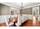 Cozy dining room featuring hardwood floors, modern chandelier, and elegant wall trim at 2656 Old Norcross Rd, Tucker, GA 30084