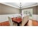 Cozy dining room featuring hardwood floors, modern chandelier, and elegant wall trim at 2656 Old Norcross Rd, Tucker, GA 30084