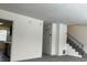 Living room with gray carpet, stairs, and access to kitchen at 6354 Shannon Pkwy # 6D, Union City, GA 30291