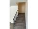 Carpeted staircase with a metal railing leading to the upper level at 6354 Shannon Pkwy # 6D, Union City, GA 30291