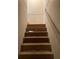 Unfinished wooden staircase leading to the lower level at 6354 Shannon Pkwy # 6D, Union City, GA 30291