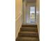 Carpeted staircase with a white railing leading to the upper level at 6354 Shannon Pkwy # 6D, Union City, GA 30291