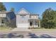 Two-story Craftsman style home with gray siding, white trim, and a two-car garage at 746 River Gardens Se Dr, Atlanta, GA 30354