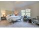 Large main bedroom with carpeted floor, a plush bed, and seating area at 746 River Gardens Se Dr, Atlanta, GA 30354