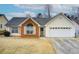 Brick and vinyl-sided house with a two-car garage at 990 Avalon Dr, Lawrenceville, GA 30044