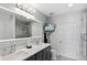 Modern bathroom with double vanity, large mirror, and walk-in shower at 855 Peachtree Ne St # 2911, Atlanta, GA 30308