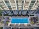 Aerial view of a large rooftop pool with lounge chairs at 855 Peachtree Ne St # 2911, Atlanta, GA 30308