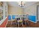 Charming dining room with wood floors and blue accent wall at 114 Delta Ct, Sharpsburg, GA 30277