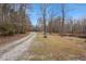 Long driveway leading to a house in a wooded area at 114 Delta Ct, Sharpsburg, GA 30277