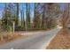 Paved driveway with a gate entrance at 114 Delta Ct, Sharpsburg, GA 30277