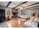 Spacious living room featuring hardwood floors, stone fireplace, and exposed wooden beams at 114 Delta Ct, Sharpsburg, GA 30277