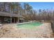 In-ground pool surrounded by trees at 114 Delta Ct, Sharpsburg, GA 30277