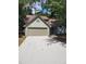 House exterior boasts a two-car garage and landscaped yard at 1442 Bailing Dr, Lawrenceville, GA 30043