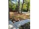 Landscaped front yard with mature trees and walkway at 1442 Bailing Dr, Lawrenceville, GA 30043