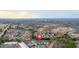 An aerial view of a residential area with rooftops, trees, and nearby commercial centers at 2540 Village Park Dr, Cumming, GA 30041