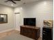 Finished basement with wood accent wall, TV, and storage at 2540 Village Park Dr, Cumming, GA 30041