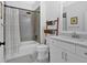 Modern bathroom with white vanity, a shower, and gray herringbone tiling at 2540 Village Park Dr, Cumming, GA 30041