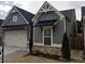 Gray craftsman style home with white accents and a two-car garage at 2540 Village Park Dr, Cumming, GA 30041