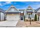 Charming single-Gathering home with gray siding, brick accents, manicured lawn, and a two-car garage at 2540 Village Park Dr, Cumming, GA 30041