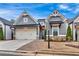 Charming single-Gathering home with gray siding, brick accents, manicured lawn, and a two-car garage at 2540 Village Park Dr, Cumming, GA 30041