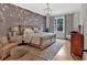 A beautiful bedroom featuring an accent wall with decorative lighting and hardwood flooring at 2540 Village Park Dr, Cumming, GA 30041