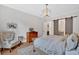 A serene bedroom with a sliding barn door, wood floors, and modern lighting at 2540 Village Park Dr, Cumming, GA 30041