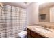 Clean bathroom with granite countertop and striped shower curtain at 275 13Th Ne St # 1106, Atlanta, GA 30309