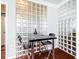 Small dining area with black table and glass block wall at 275 13Th Ne St # 1106, Atlanta, GA 30309