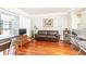 Living room boasts hardwood floors and a brown leather sofa with balcony access at 275 13Th Ne St # 1106, Atlanta, GA 30309