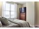 Bedroom with queen bed, dresser, and large window at 325 E Paces Ferry Ne Rd # 806, Atlanta, GA 30305