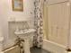 Small basement bathroom with pedestal sink and shower/tub at 5078 Hubert Dr, Powder Springs, GA 30127