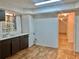 Small basement kitchen with dark cabinets and linoleum floor at 5078 Hubert Dr, Powder Springs, GA 30127