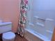 Clean bathroom with shower/tub combo and floral shower curtain at 5078 Hubert Dr, Powder Springs, GA 30127