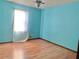 Simple bedroom with light blue walls and wood flooring at 5078 Hubert Dr, Powder Springs, GA 30127