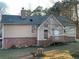 Tan house with brick base, deck and mature trees at 5078 Hubert Dr, Powder Springs, GA 30127