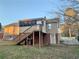 Back of house with sunroom and stairs leading to the ground at 5078 Hubert Dr, Powder Springs, GA 30127