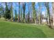The backyard shows a large lawn with trees in the background of the property at 2019 Arlington Nw Cir, Atlanta, GA 30318