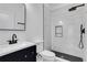 Sleek bathroom featuring a vanity sink, modern toilet, and a walk-in shower with black fixtures at 2019 Arlington Nw Cir, Atlanta, GA 30318