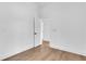 Minimalist bedroom with light wood floors, white walls, and a doorway to an adjacent room at 2019 Arlington Nw Cir, Atlanta, GA 30318