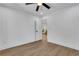 Inviting bedroom with light wood floors, white walls, ceiling fan, and doorway leading to another room at 2019 Arlington Nw Cir, Atlanta, GA 30318