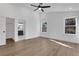 Bright bedroom features wood-look floors, a ceiling fan, and ensuite bathroom with an enclosed shower at 2019 Arlington Nw Cir, Atlanta, GA 30318