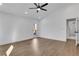 Bright bedroom with light wood floors, white walls, ceiling fan, and a doorway to the bathroom at 2019 Arlington Nw Cir, Atlanta, GA 30318